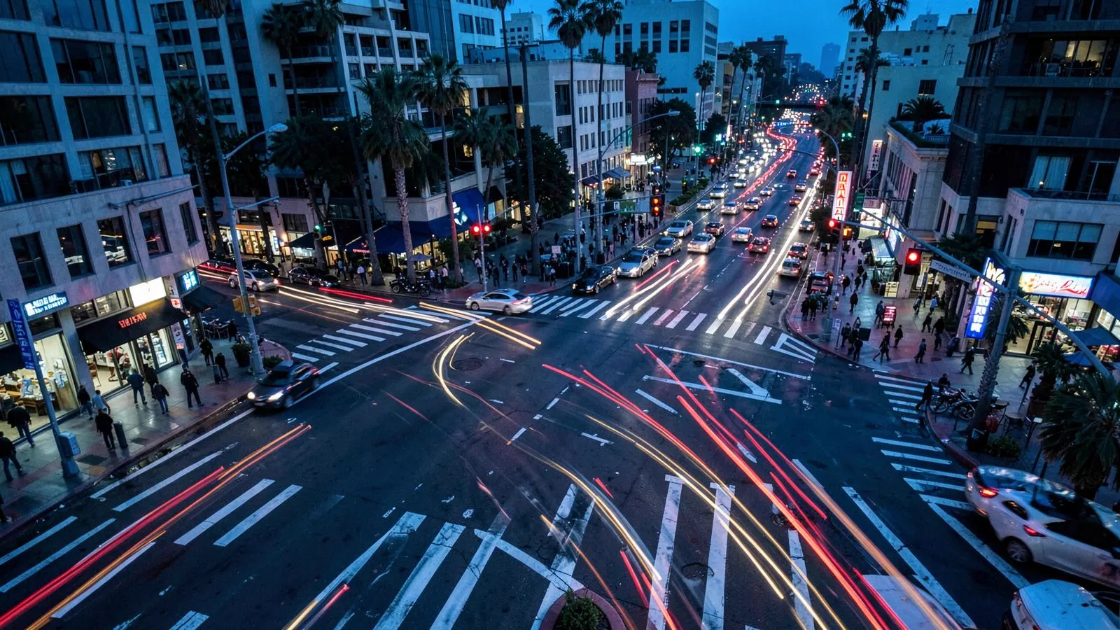 Busy Los Angeles intersection at dusk with traffic light trails