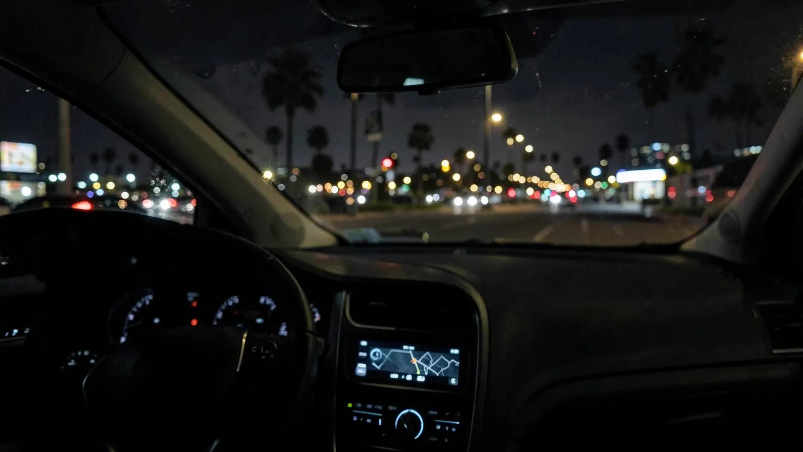 View from inside a rideshare vehicle driving through Los Angeles at night